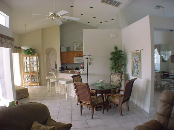 8949 Lely Island Circle Naples, FL 34113 - Photo 3 of 11 a view of a dining room with furniture