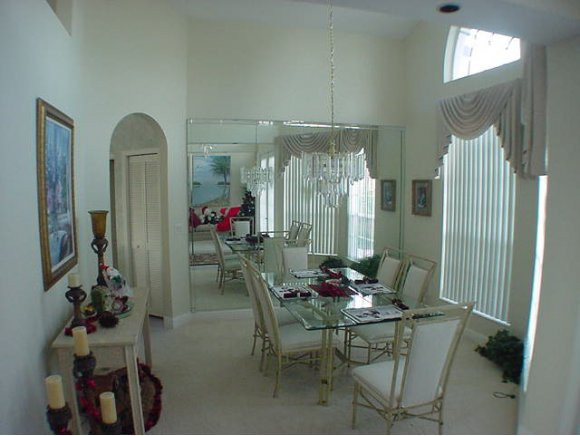8949 Lely Island Circle Naples, FL 34113 - Photo 4 of 11 a dining room with furniture and window