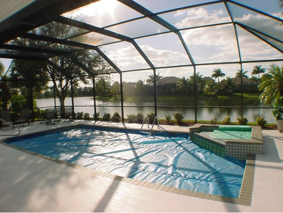 8949 Lely Island Circle Naples, FL 34113 - Photo 8 of 11 a view of a swimming pool with a patio and a yard