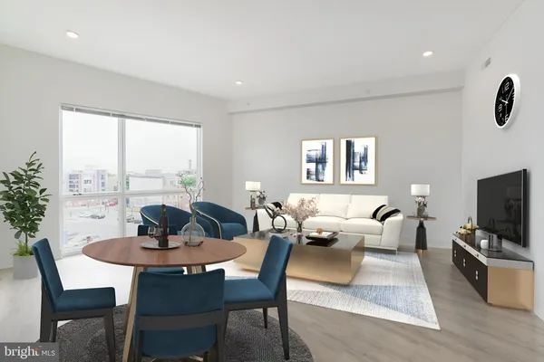 a living room with furniture a flat screen tv and a large window