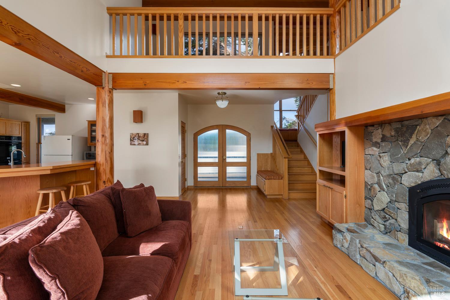116 Shepherds Close The Sea Ranch, CA 95497 - Photo 15 of 65 a living room with furniture a fireplace and wooden floor