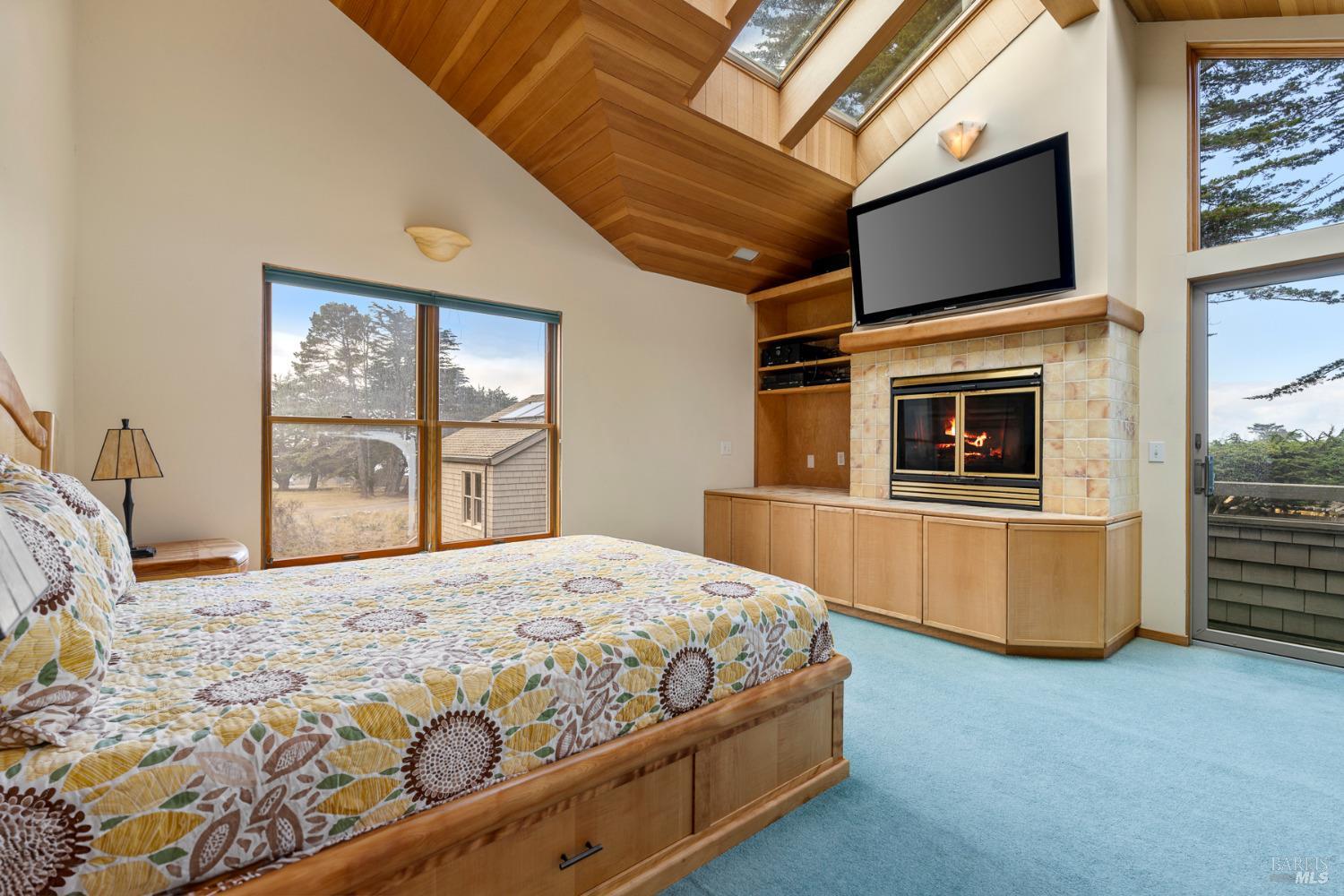 116 Shepherds Close The Sea Ranch, CA 95497 - Photo 29 of 65 a bedroom with a large bed and a flat tv screen on dresser