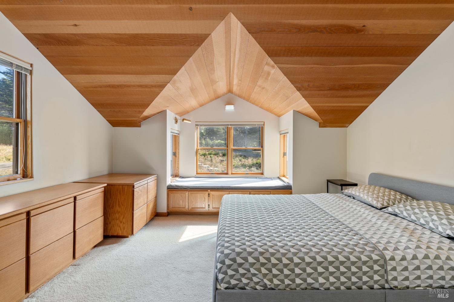 116 Shepherds Close The Sea Ranch, CA 95497 - Photo 36 of 65 a spacious bedroom with a large bed and a large window