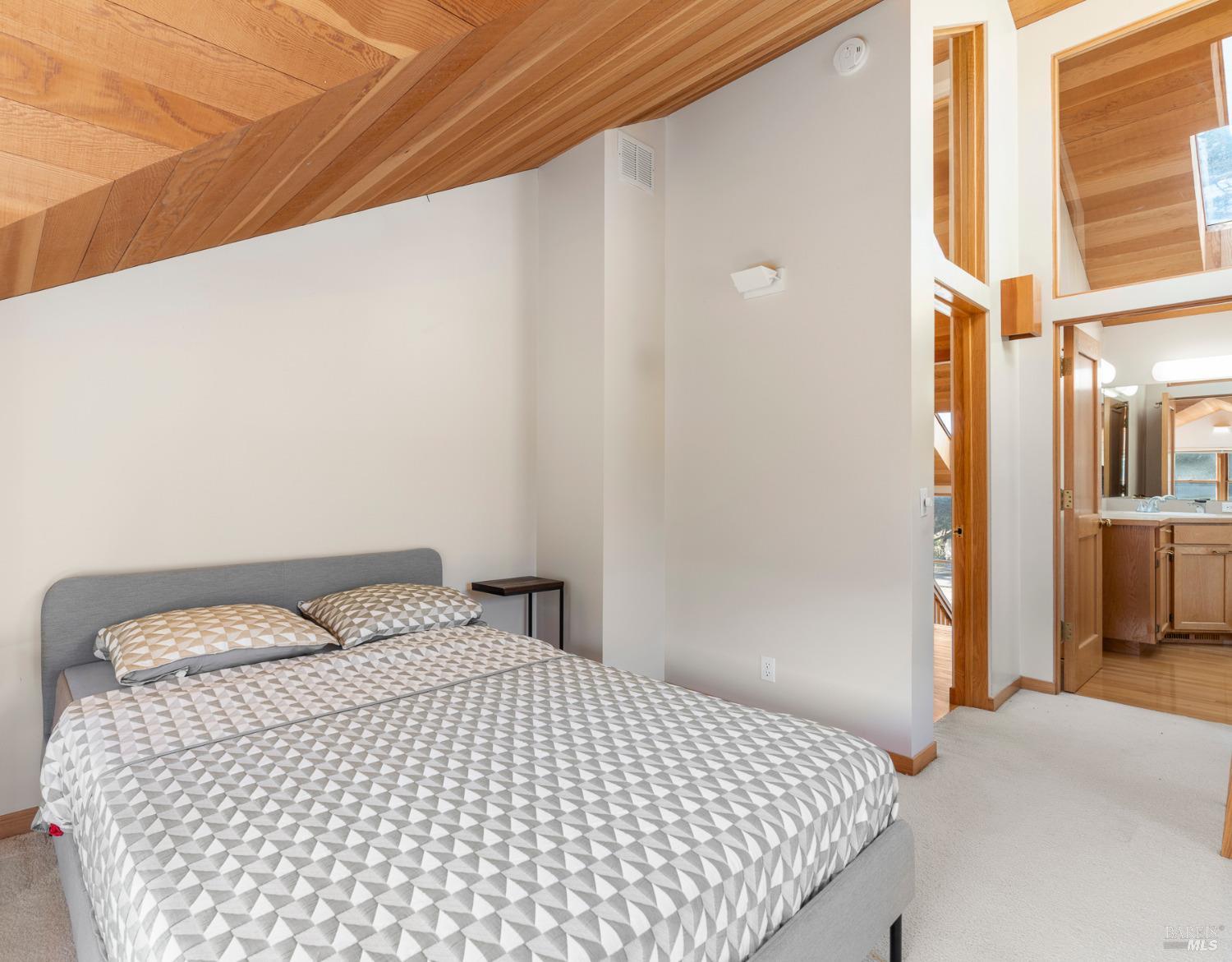 116 Shepherds Close The Sea Ranch, CA 95497 - Photo 38 of 65 a bedroom with a bed and a cabinets