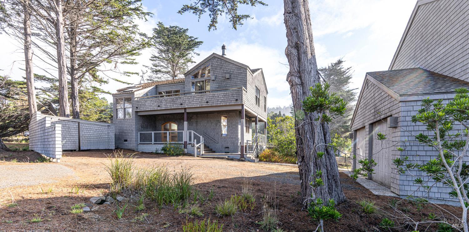 116 Shepherds Close The Sea Ranch, CA 95497 - Photo 4 of 65 a front view of a house with a yard and garage