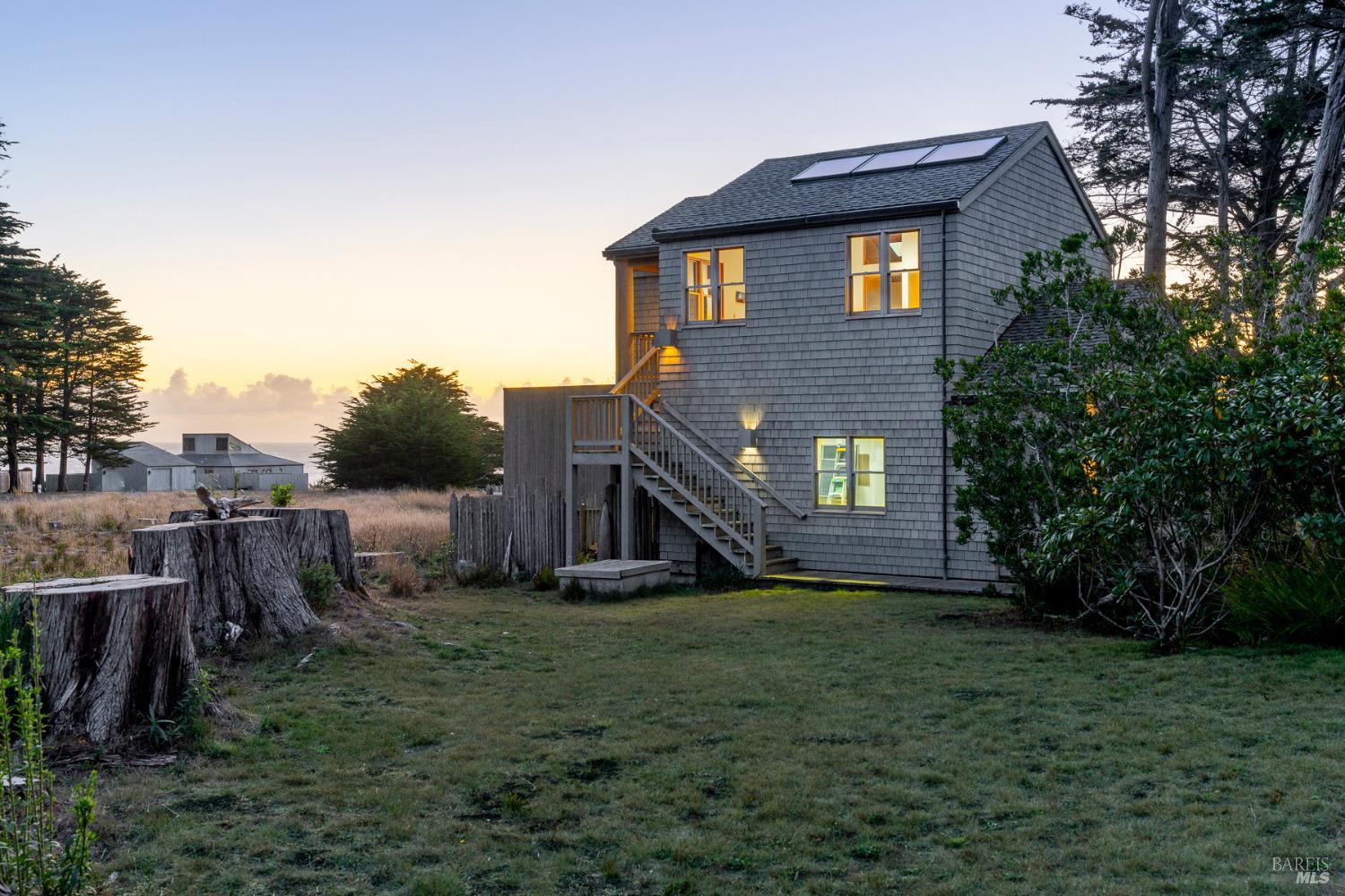 116 Shepherds Close The Sea Ranch, CA 95497 - Photo 60 of 65 a brick house with a large windows next to a yard