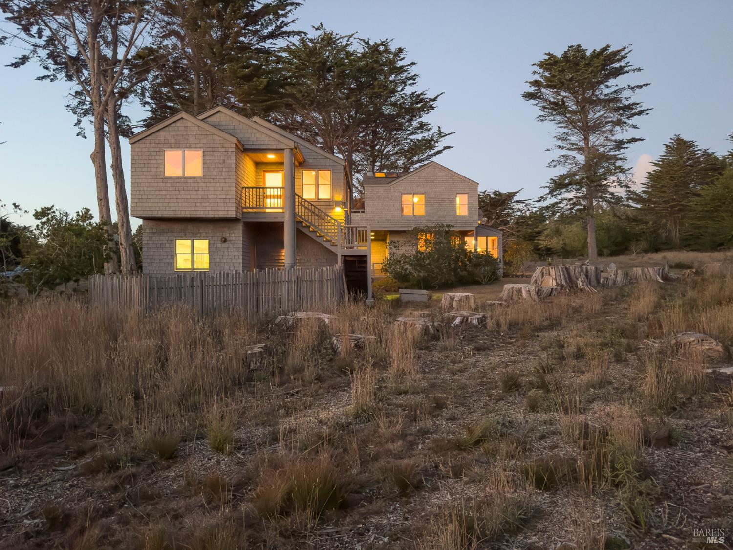 116 Shepherds Close The Sea Ranch, CA 95497 - Photo 65 of 65 a front view of a house with a yard and large tree