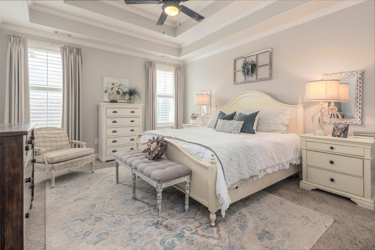 608 Cypress Run Cove Collierville, TN 38017 - Photo 18 of 40 Bedroom with light carpet, a ceiling fan, a raised ceiling, and ornamental molding