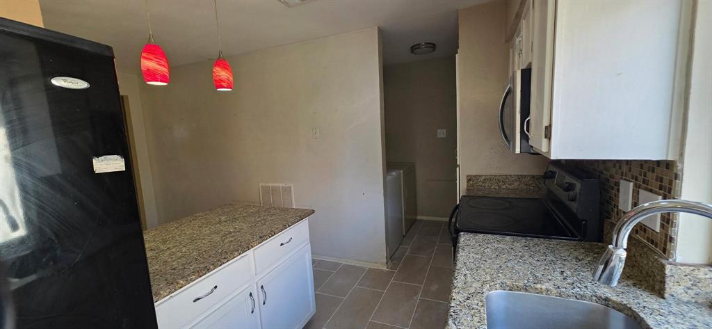 1756 Crystal Way Plano, TX 75074 - Photo 3 of 14 a kitchen with granite countertop a sink and cabinets