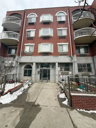 a view of a brick building with many windows