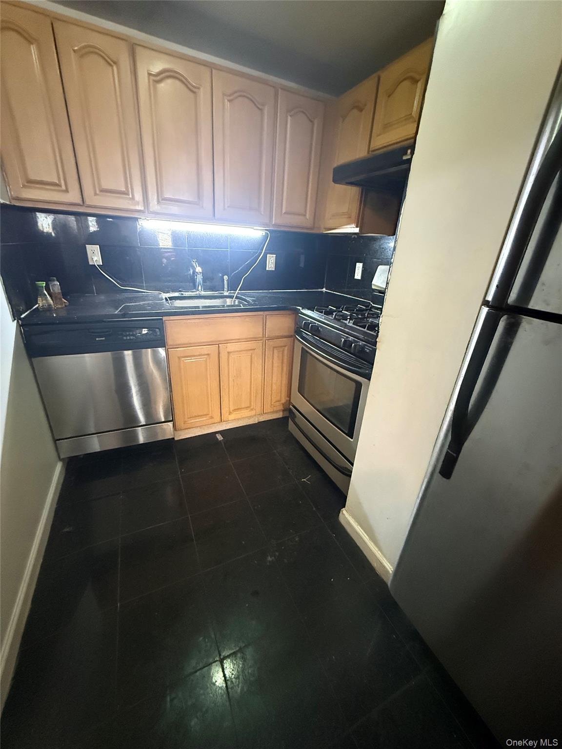 112-31 38th Avenue, Unit 3D Queens, NY 11368 - Photo 6 of 8 a kitchen with a sink a stove and cabinets