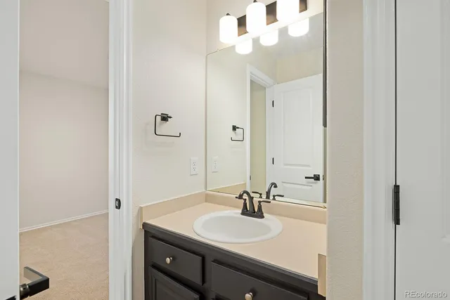 a white toilet sitting next to a white sink
