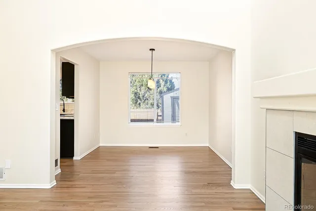 a view of a room with wooden floor and a window