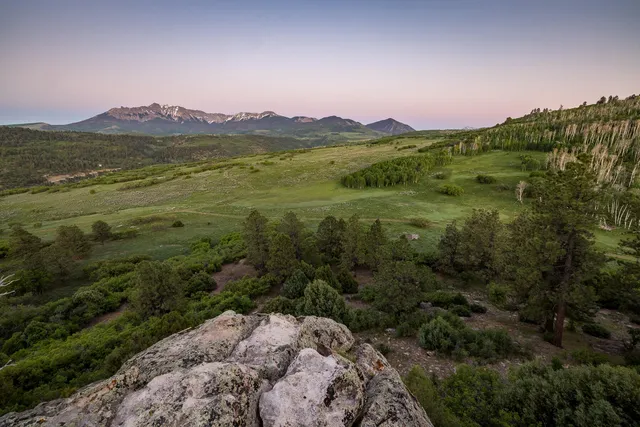 a view of a town with mountains in the background