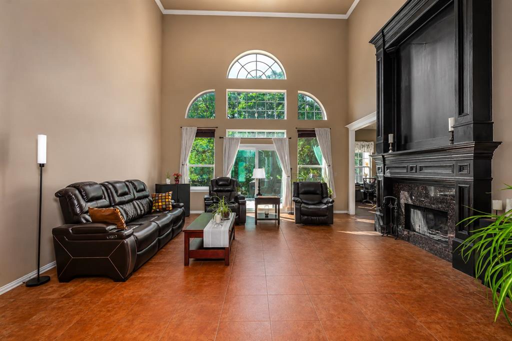 100 Manders Court Runaway Bay, TX 76426 - Photo 6 of 33 a living room with furniture a fireplace and a large window
