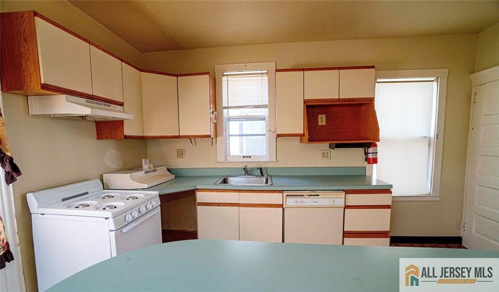 52 Ellen Street New Brunswick, NJ 08901 - Photo 2 of 5 a kitchen with a sink a stove and cabinets