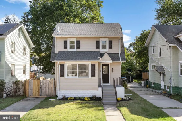 a front view of a house with a yard garage and outdoor seating