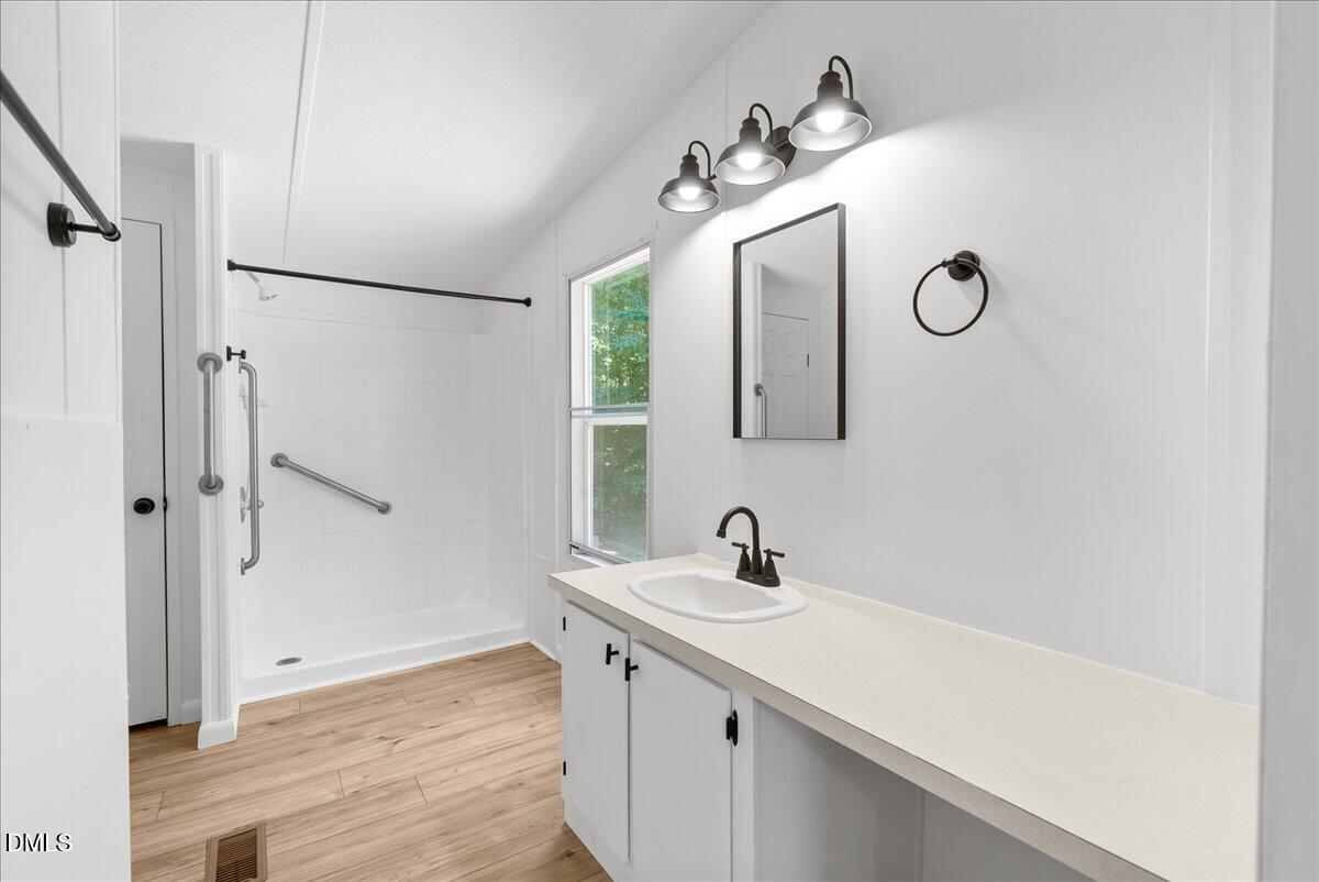 1111 Stoney Mountain Road Rougemont, NC 27572 - Photo 17 of 30 a bathroom with a sink and a mirror
