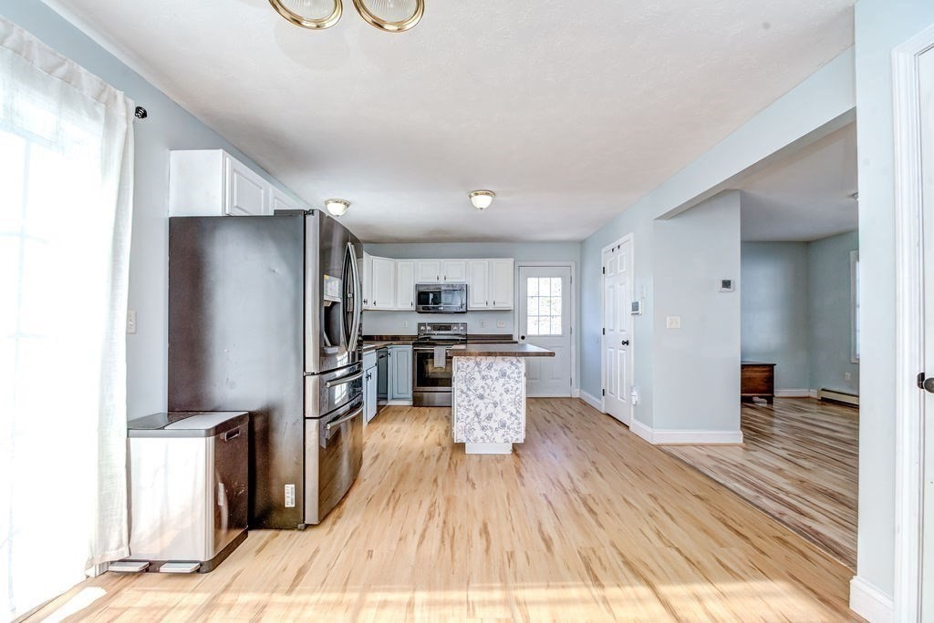 40 Sawyer Street Gardner, MA 01440 - Photo 13 of 37 a kitchen with stainless steel appliances kitchen island granite countertop a refrigerator and a sink