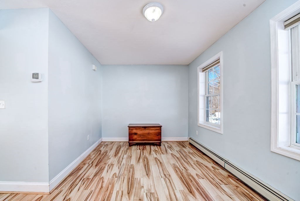 40 Sawyer Street Gardner, MA 01440 - Photo 15 of 37 an empty room with wooden floor and windows