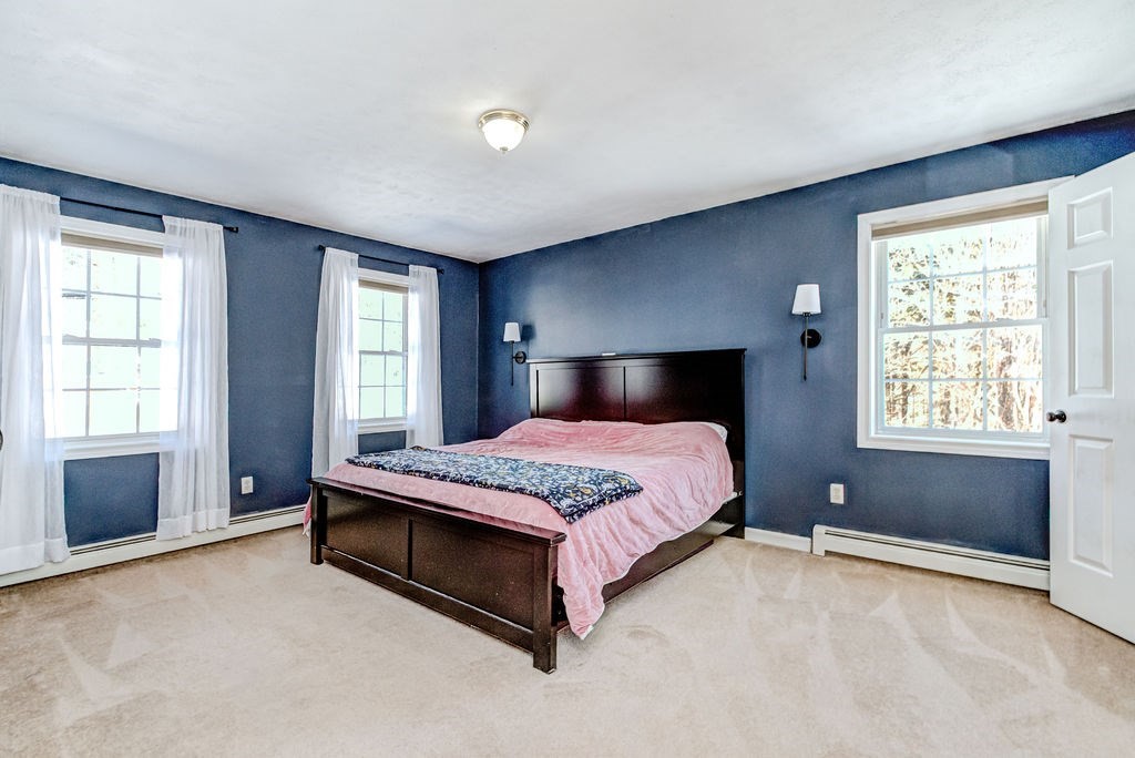 40 Sawyer Street Gardner, MA 01440 - Photo 18 of 37 a spacious bedroom with a bed and a window