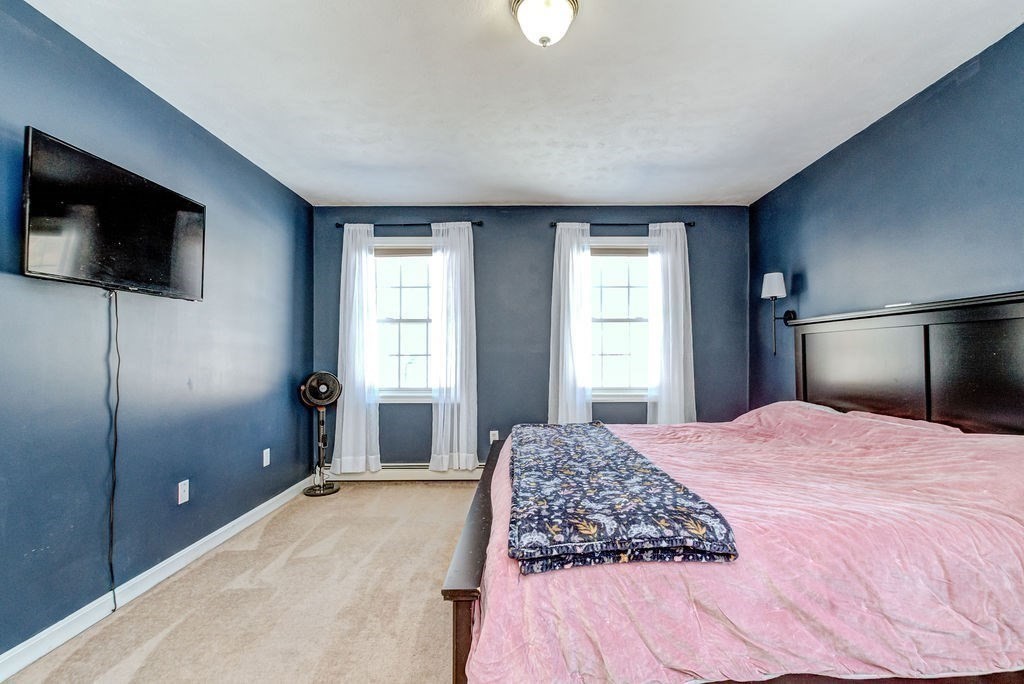 40 Sawyer Street Gardner, MA 01440 - Photo 19 of 37 a spacious bedroom with a large bed and a flat screen tv