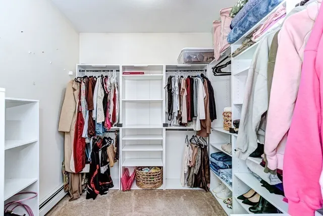 a view of walk in closet with clothes
