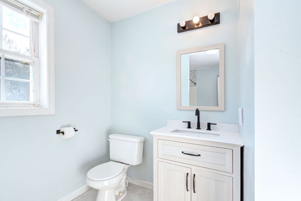 40 Sawyer Street Gardner, MA 01440 - Photo 23 of 37 a bathroom with a toilet sink vanity and mirror