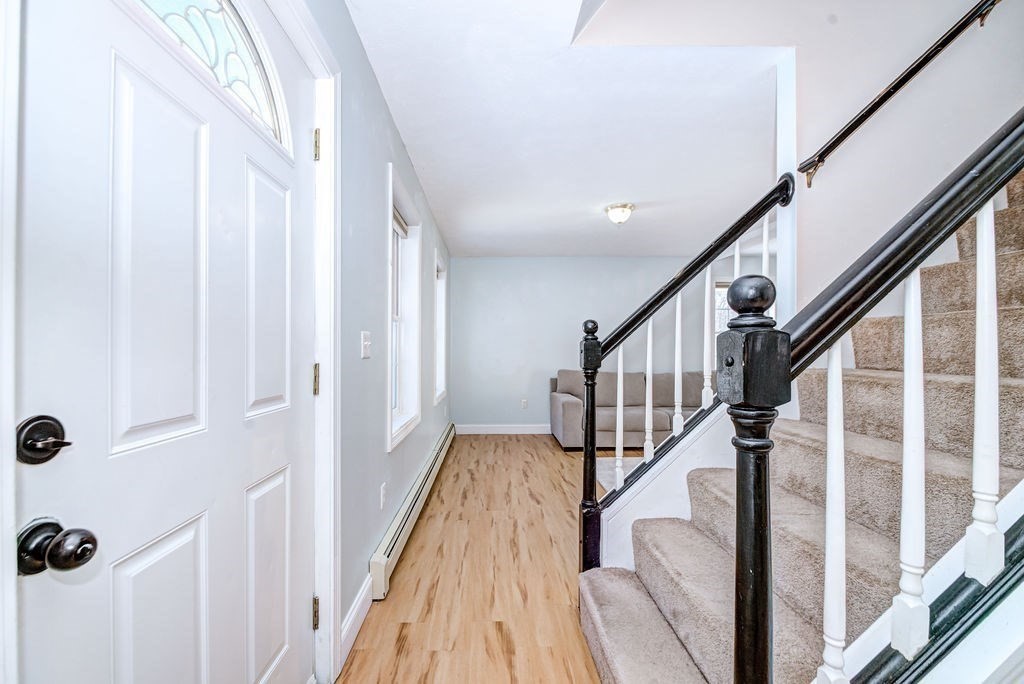 40 Sawyer Street Gardner, MA 01440 - Photo 3 of 37 a view of staircase with wooden floor and fan