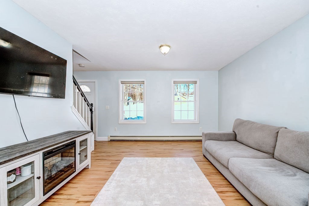 40 Sawyer Street Gardner, MA 01440 - Photo 4 of 37 a living room with a flat screen tv on dresser and a window