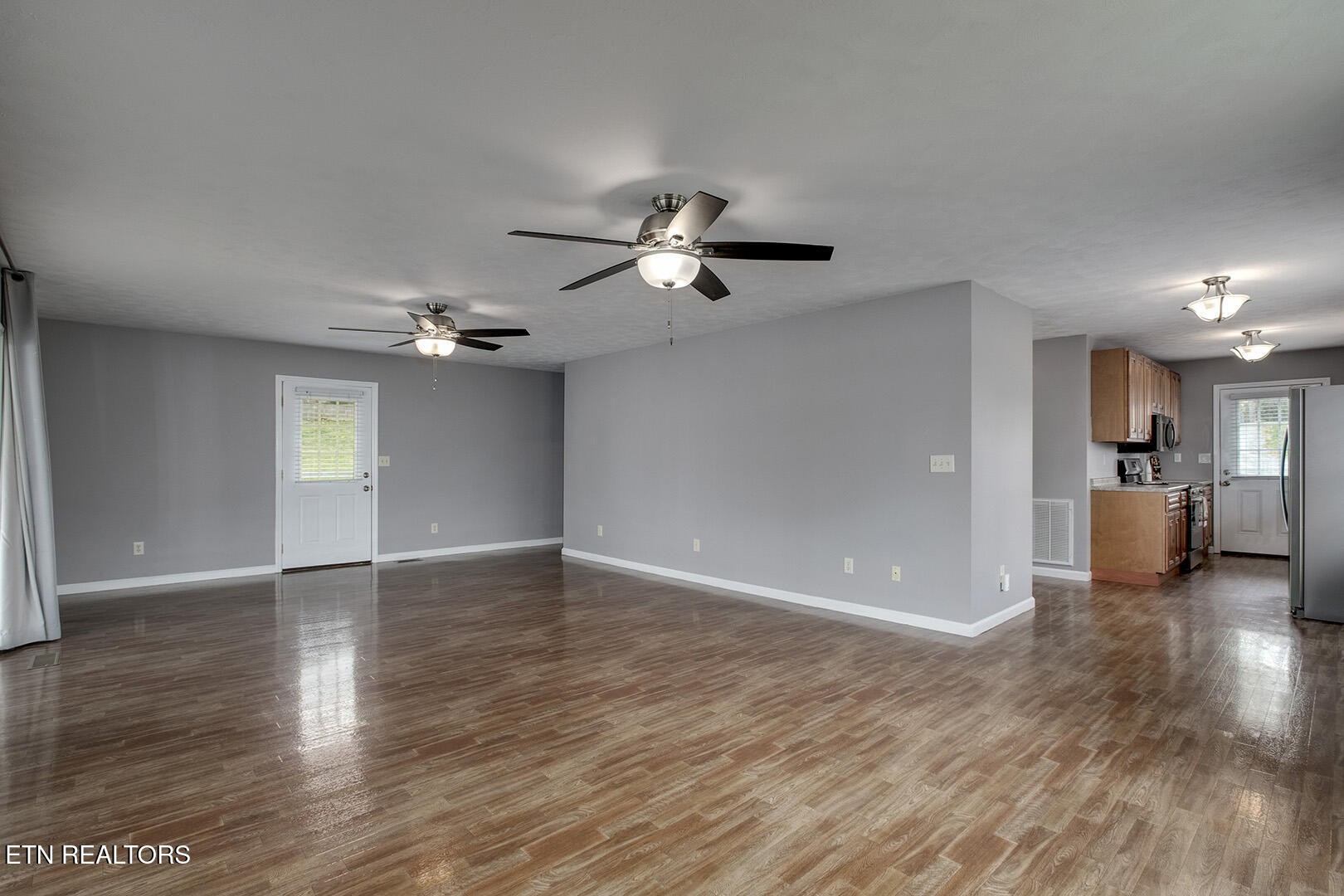609 Lakewood Drive Decatur, TN 37322 - Photo 15 of 60 a view of empty room with wooden floor and ceiling fan