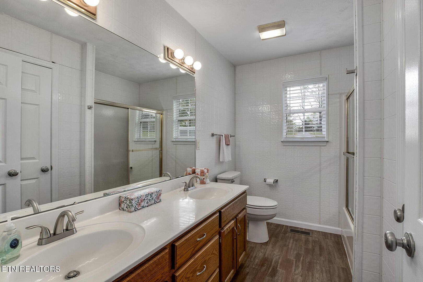 609 Lakewood Drive Decatur, TN 37322 - Photo 17 of 60 a bathroom with a sink double vanity granite and a toilet