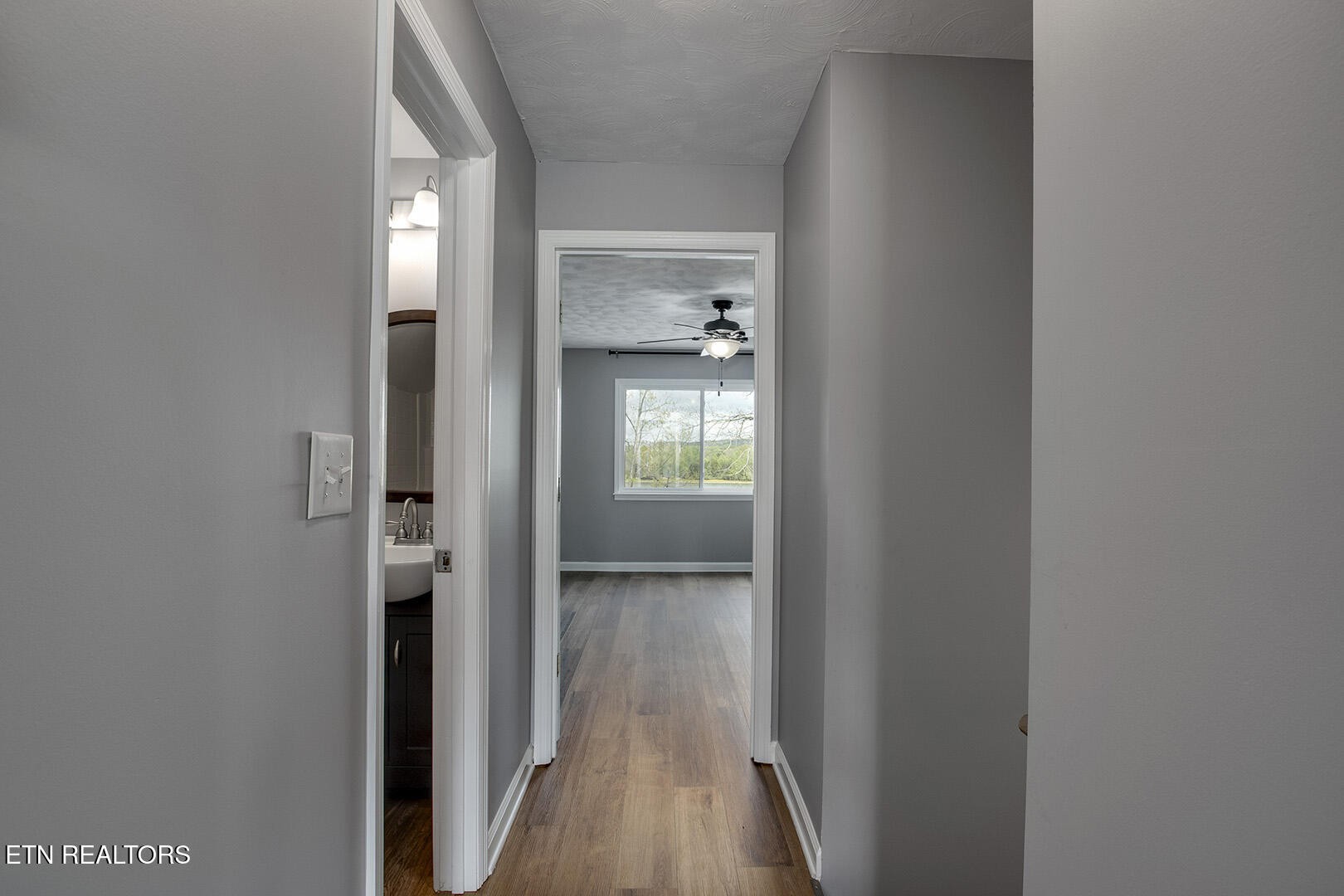 609 Lakewood Drive Decatur, TN 37322 - Photo 25 of 60 a view of a hallway with wooden floor and a bathroom