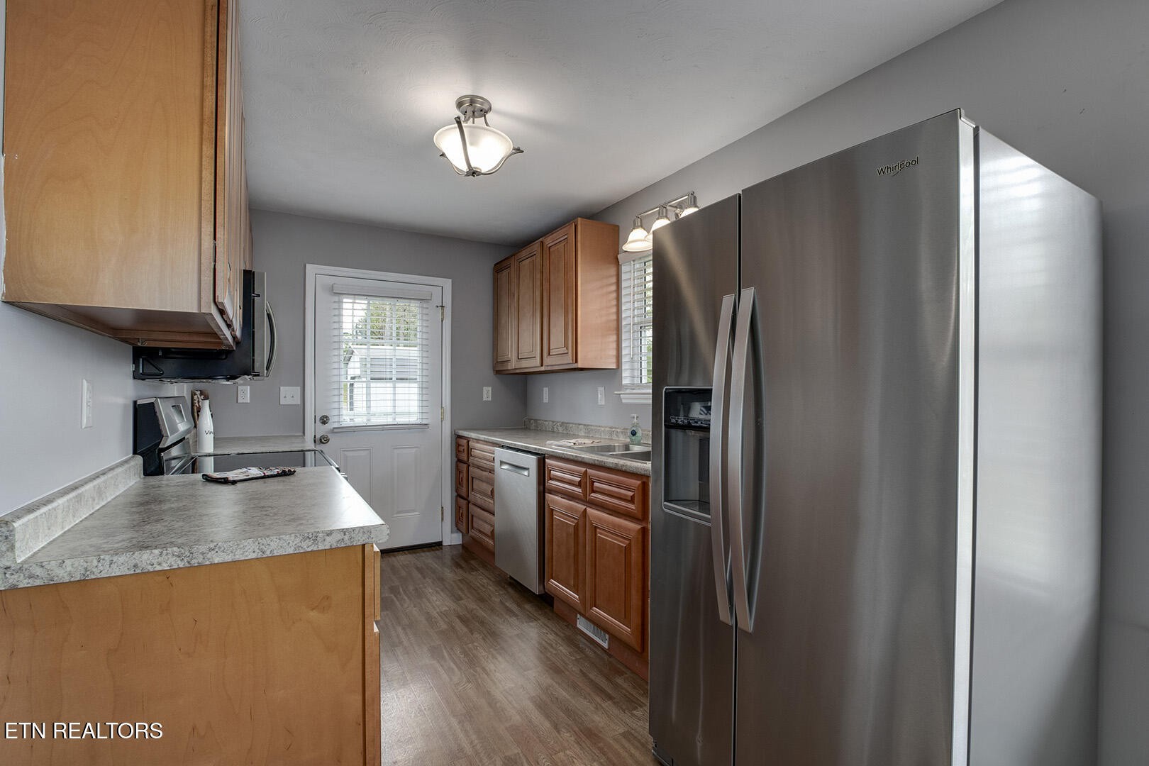 609 Lakewood Drive Decatur, TN 37322 - Photo 7 of 60 a kitchen with stainless steel appliances granite countertop a refrigerator stove and sink