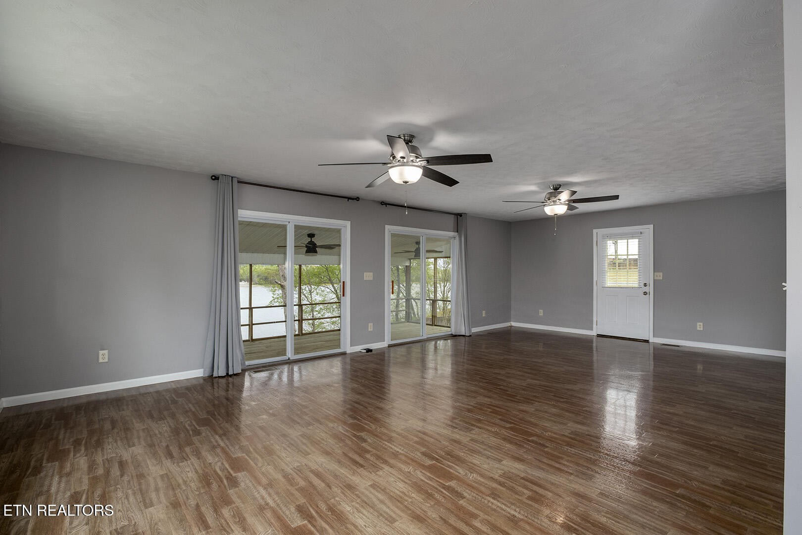 609 Lakewood Drive Decatur, TN 37322 - Photo 9 of 60 a view of an empty room with wooden floor and a window