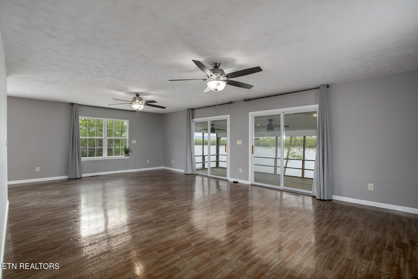609 Lakewood Drive Decatur, TN 37322 - Photo 10 of 60 a view of an empty room with wooden floor and a window
