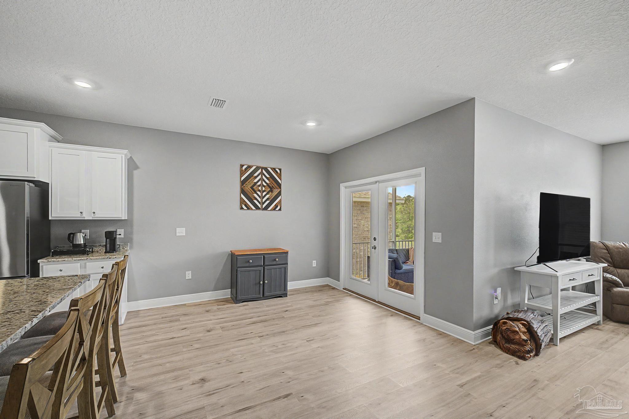 7902 Burnside Loop Pensacola, FL 32526 - Photo 12 of 47 a view of a kitchen with furniture and wooden floor