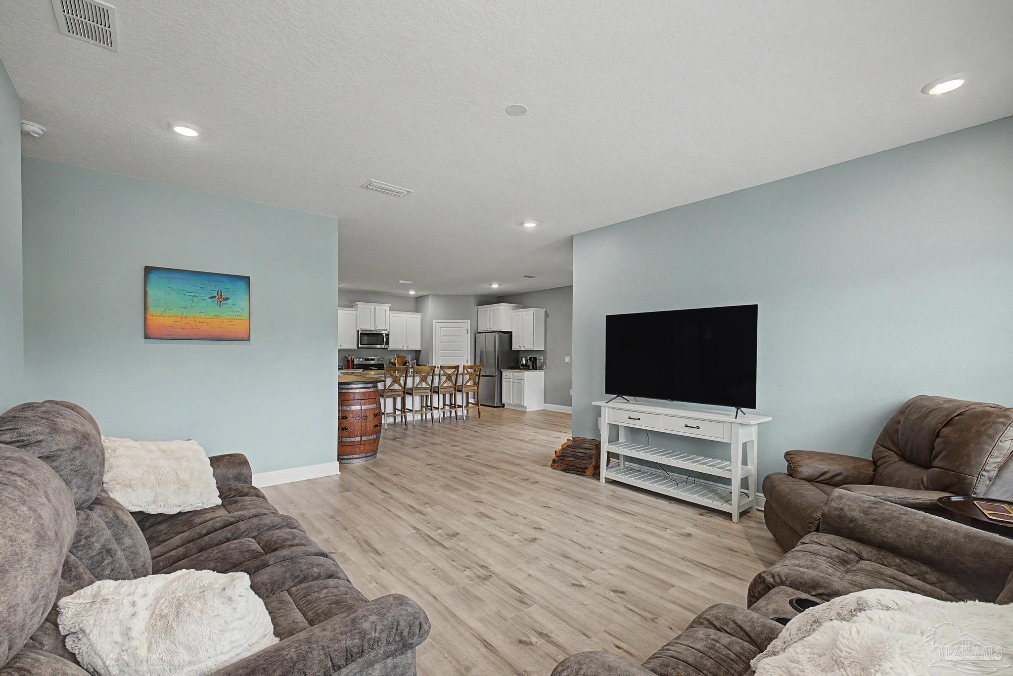 7902 Burnside Loop Pensacola, FL 32526 - Photo 14 of 47 a living room with furniture and a flat screen tv