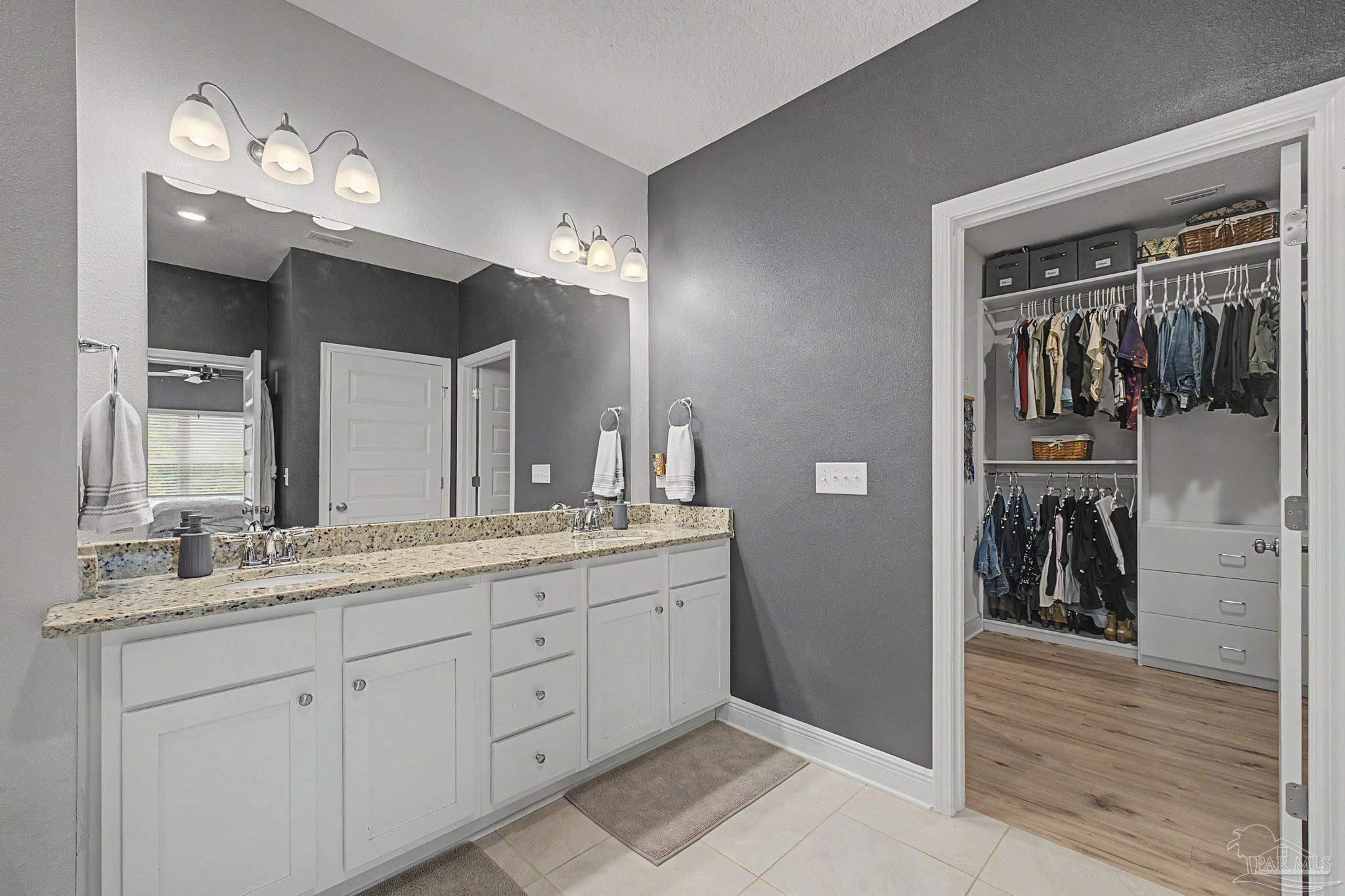 7902 Burnside Loop Pensacola, FL 32526 - Photo 20 of 47 a spacious bathroom with a granite countertop sink vanity and mirror