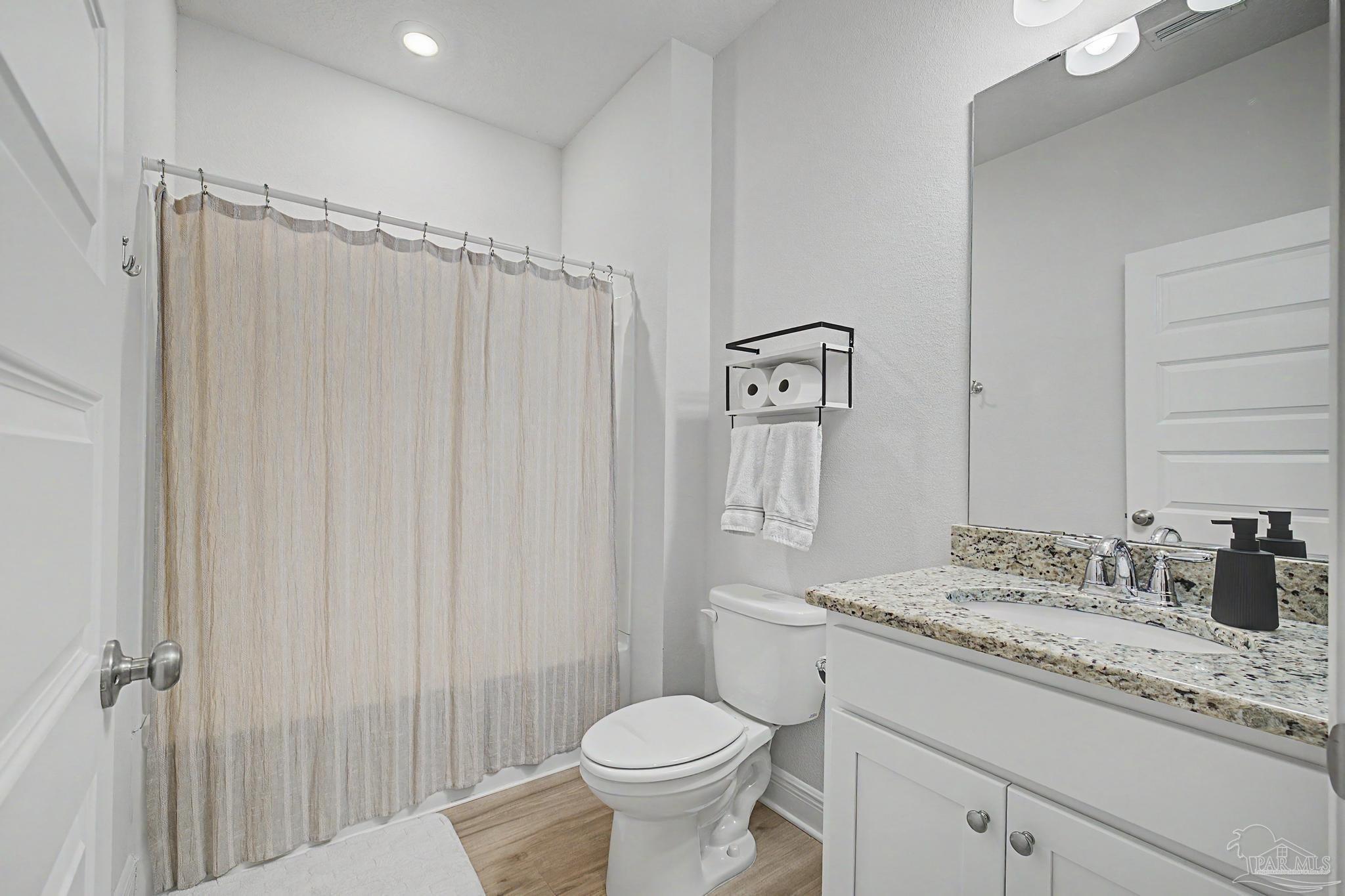 7902 Burnside Loop Pensacola, FL 32526 - Photo 25 of 47 a bathroom with a granite countertop sink toilet and a mirror