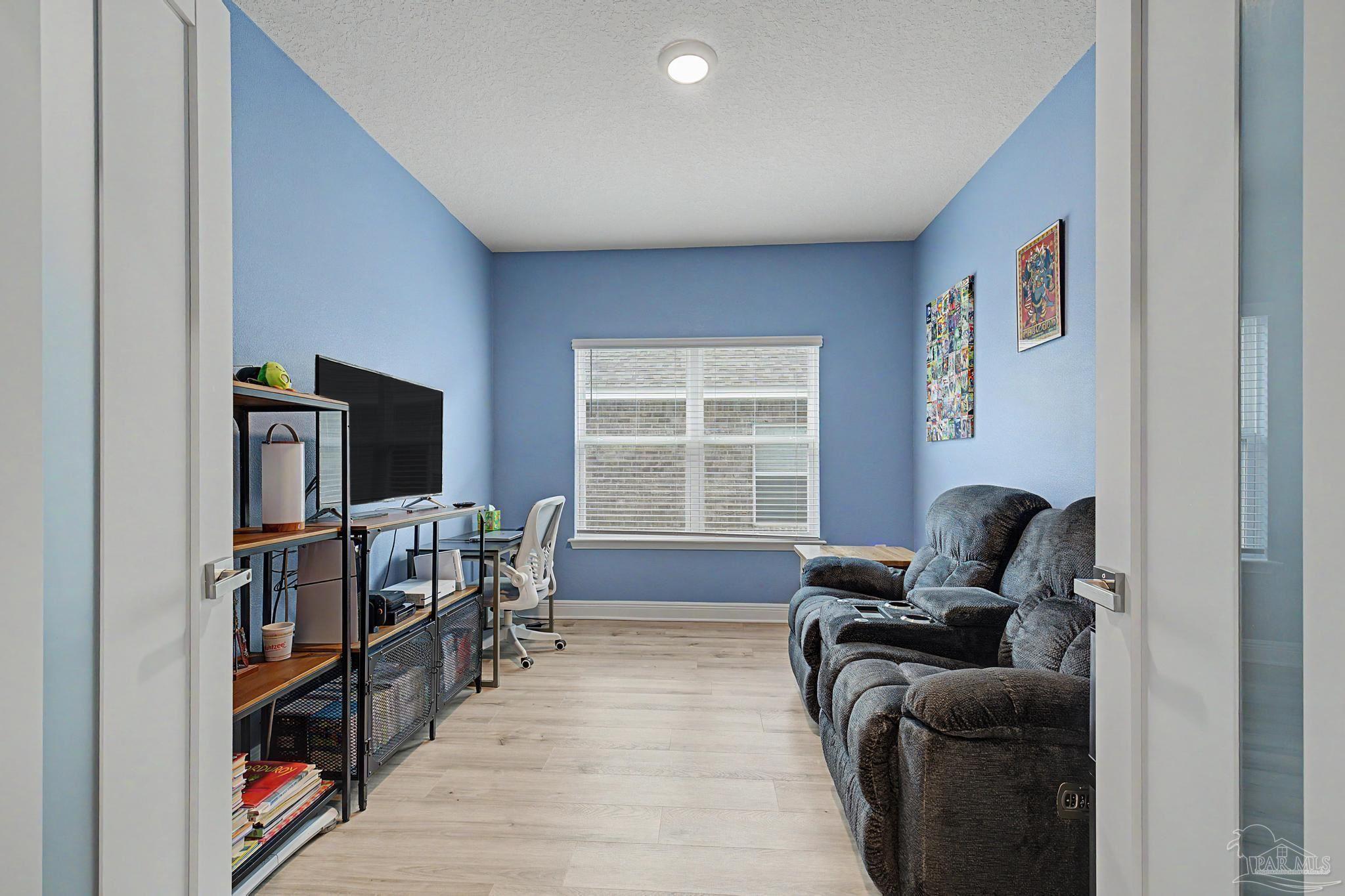 7902 Burnside Loop Pensacola, FL 32526 - Photo 27 of 47 a living room with furniture a flat screen tv and a window