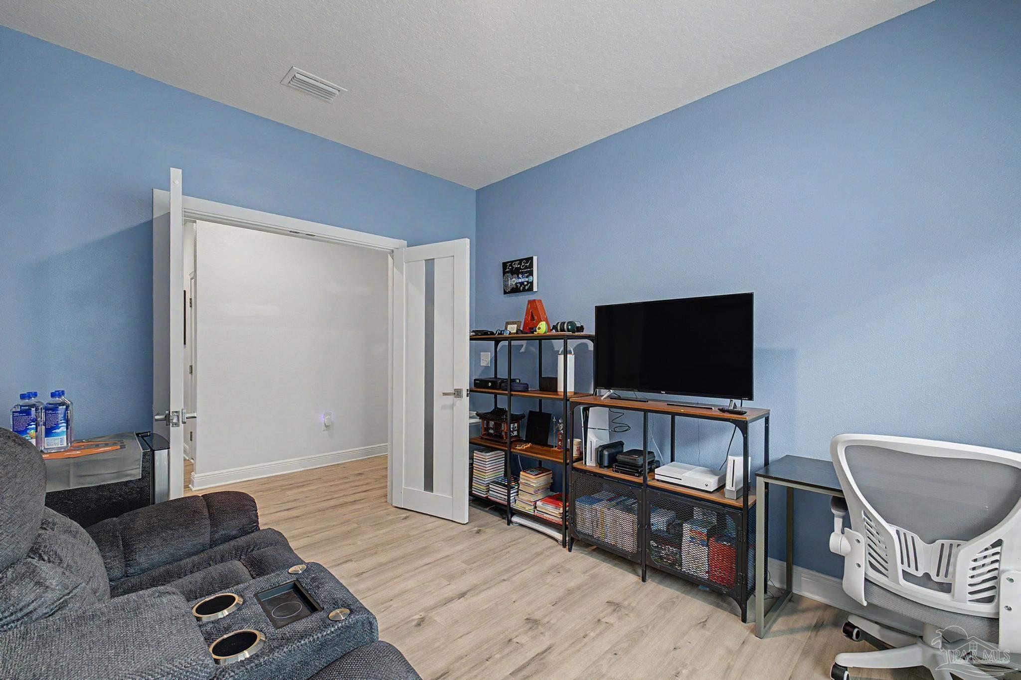 7902 Burnside Loop Pensacola, FL 32526 - Photo 28 of 47 a living room with furniture and a flat screen tv