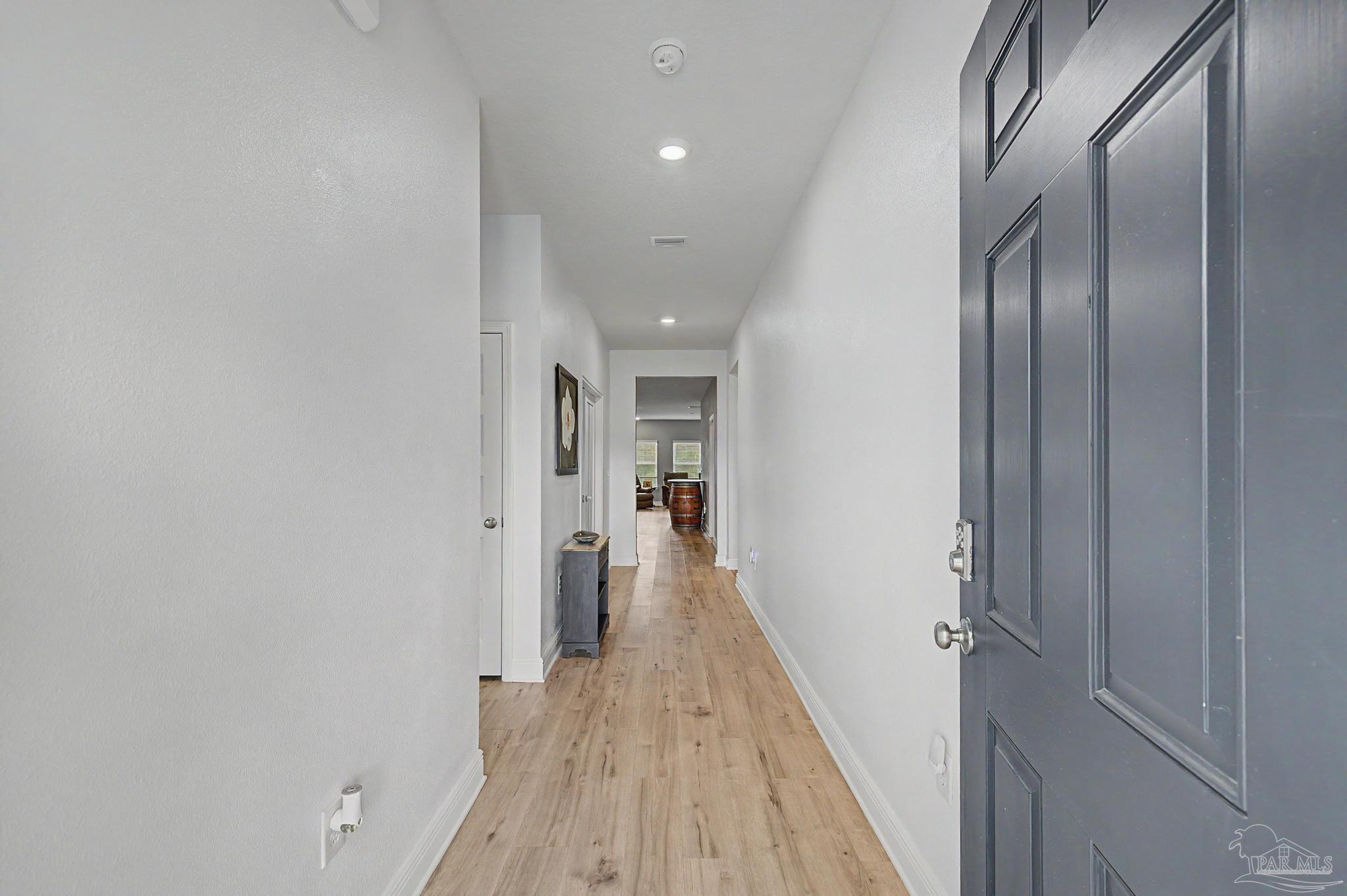 7902 Burnside Loop Pensacola, FL 32526 - Photo 3 of 47 a view of a hallway with wooden floor and staircase