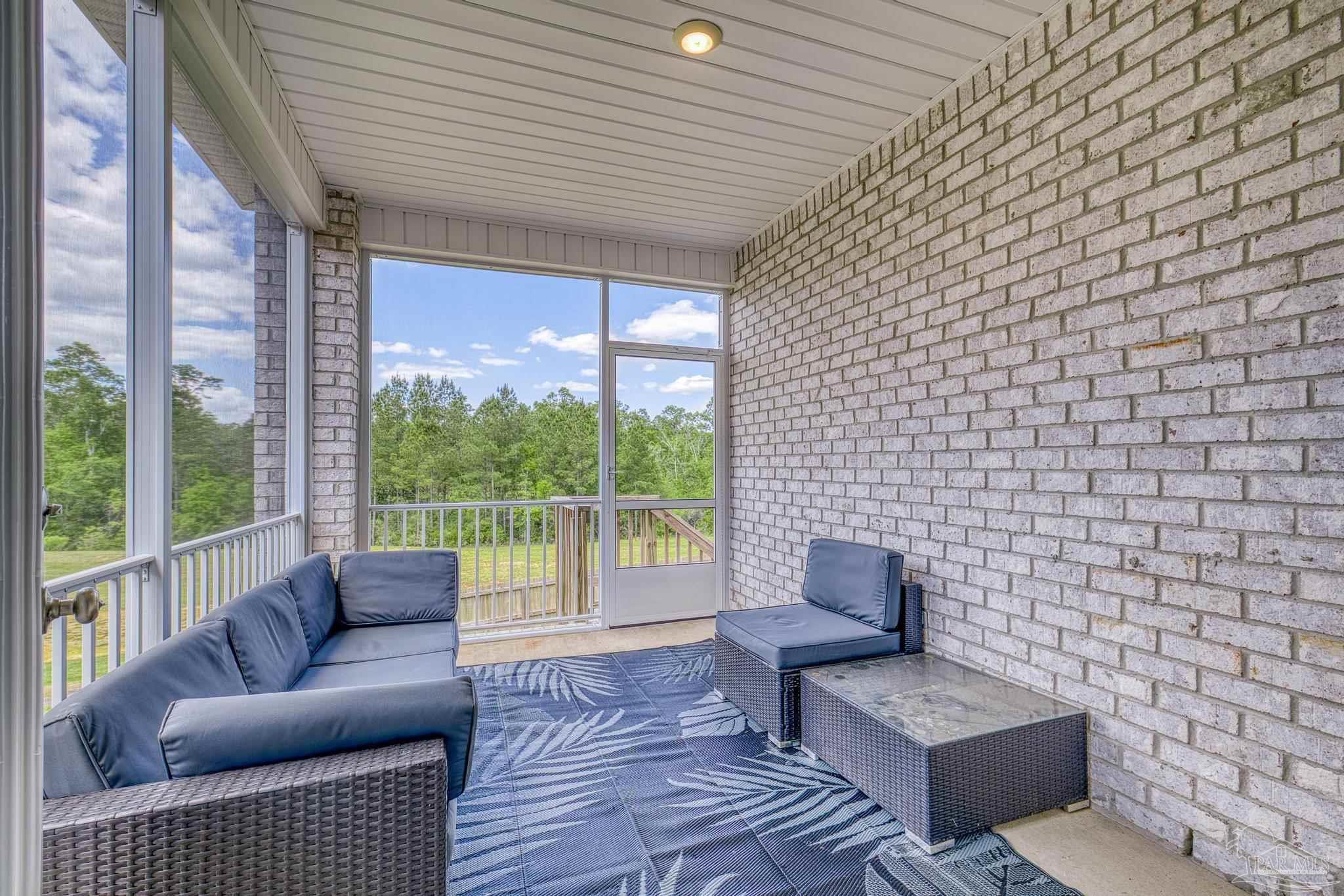 7902 Burnside Loop Pensacola, FL 32526 - Photo 31 of 47 a living room with furniture and a floor to ceiling window