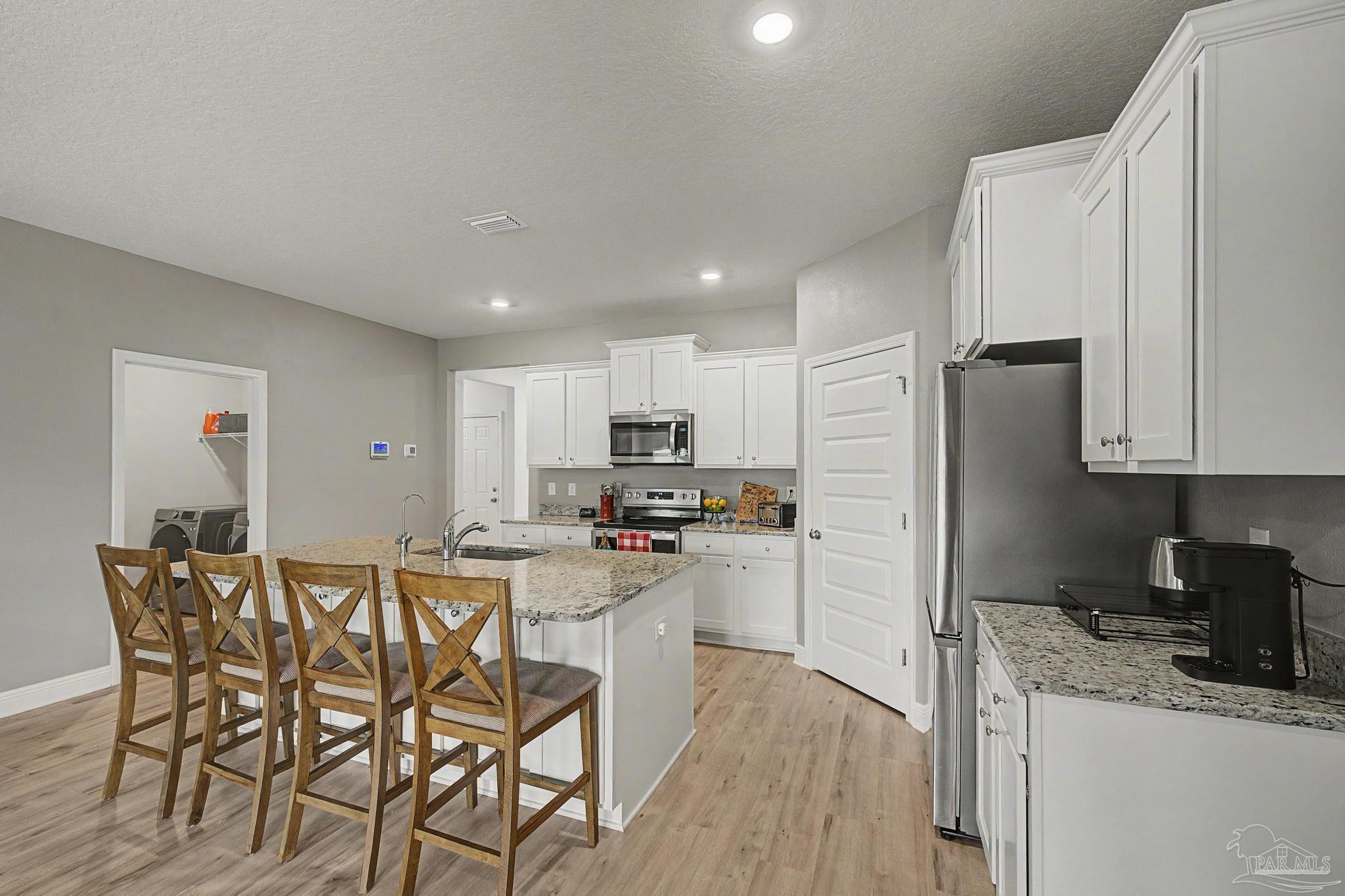 7902 Burnside Loop Pensacola, FL 32526 - Photo 9 of 47 a kitchen with a table and chairs in it