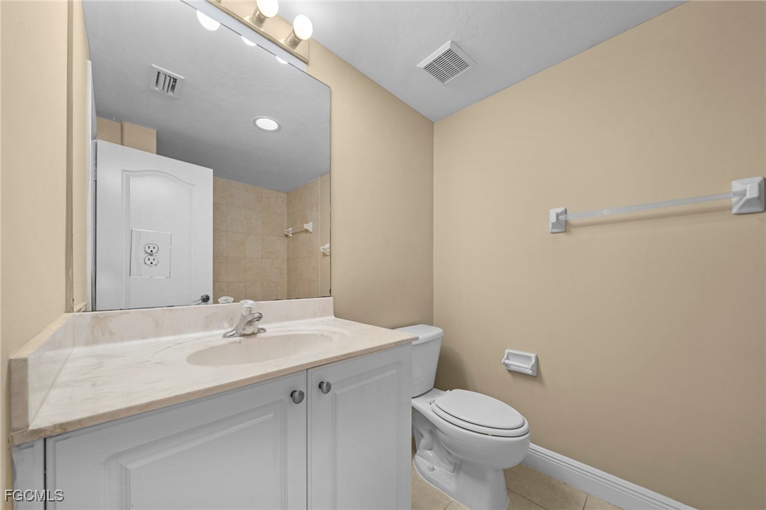 4110 Castilla Circle, Unit 105 Fort Myers, FL 33916 - Photo 14 of 37 a bathroom with a sink a toilet and mirror