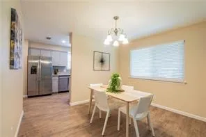 a view of a dining room with furniture and chandelier