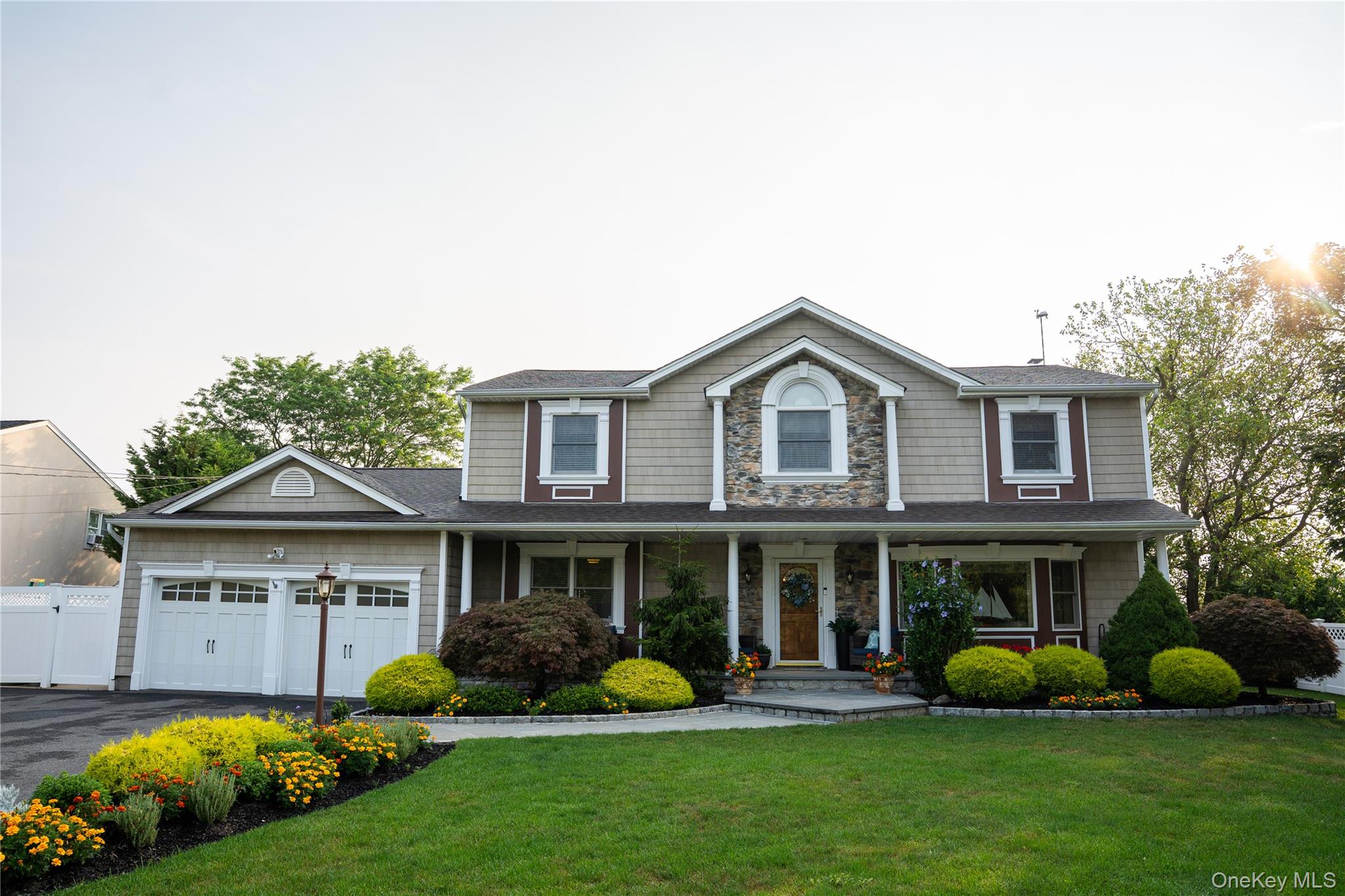 209 Blue Point Road Oakdale, NY 11769 - Photo 1 of 1 View of front of home feature custom finishes, large driveway and 2 car garage