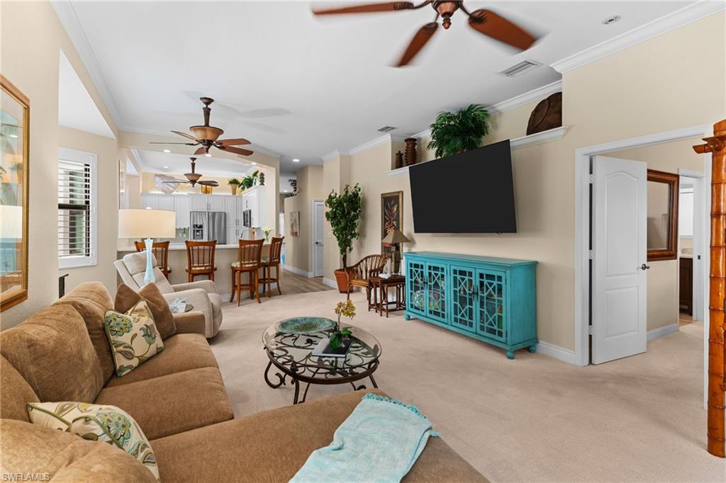 2421 Ravenna Boulevard, Unit 202 Naples, FL 34109 - Photo 11 of 42 a living room with furniture and a flat screen tv