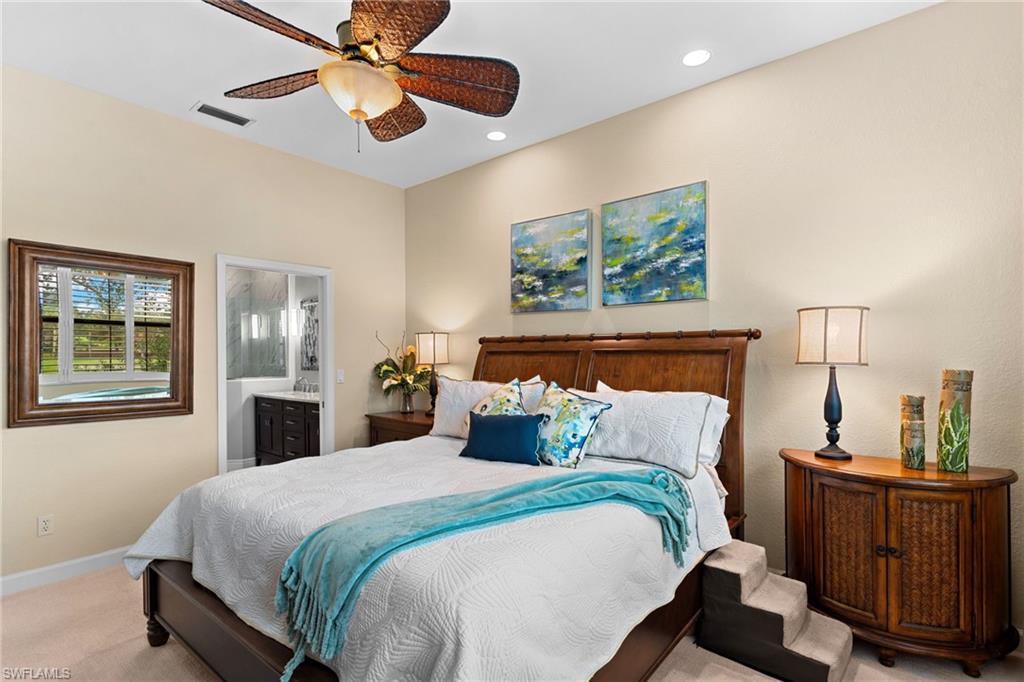 2421 Ravenna Boulevard, Unit 202 Naples, FL 34109 - Photo 13 of 42 a bedroom with a bed and wooden floor